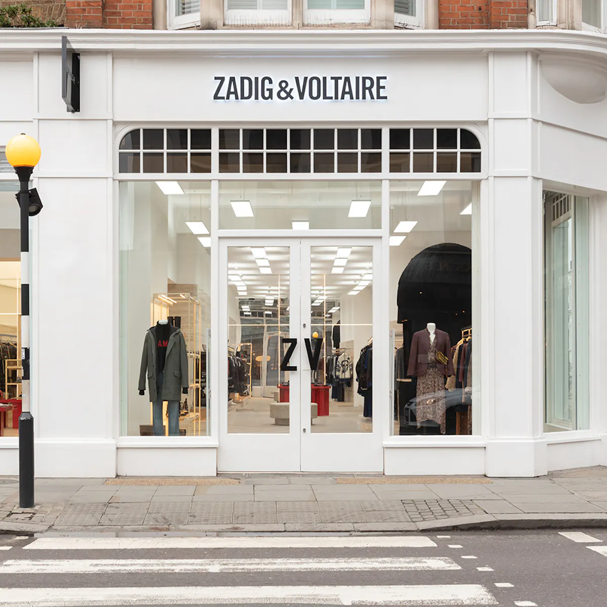 White façade of the boutique at 164-166 King’s Road: black Zadig&Voltaire sign, windows with arched transoms and a glass door marked ZV.