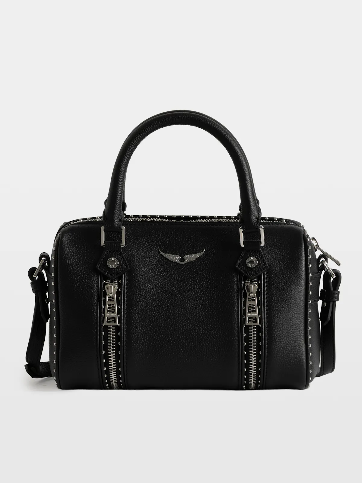 Sunny bag in black leather with two handles, silver zips and wings, on a grey studio background.